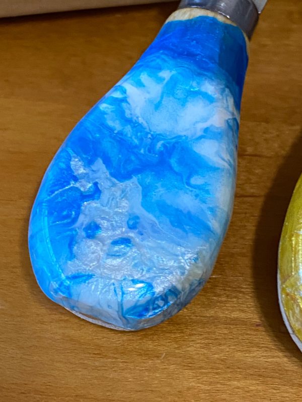 blue pour painted cheese knife close up