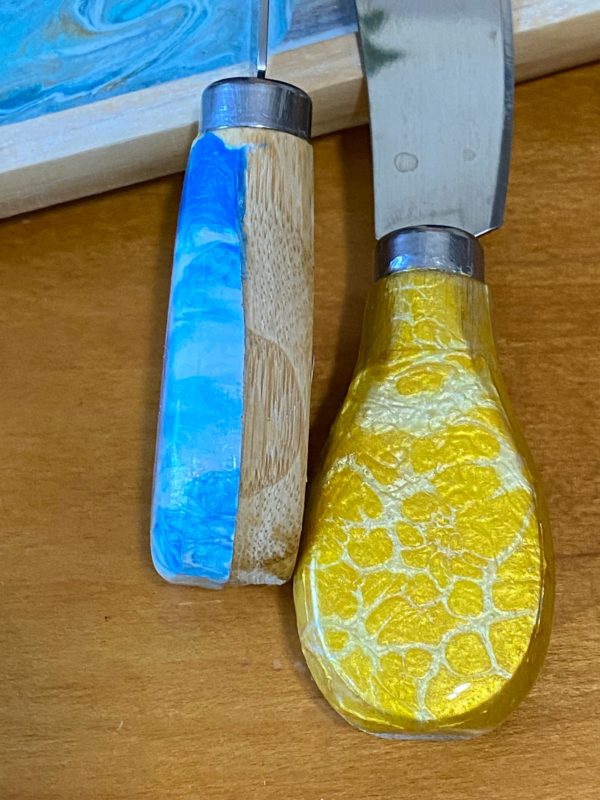 pour painted cheese knives close up yellow