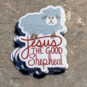 Stack of stickers with cartoon sheep and text Jesus The Good Shepherd on textured surface