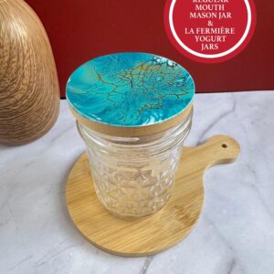Glass mason jar with textured diamond pattern and blue decorative lid on wooden board.