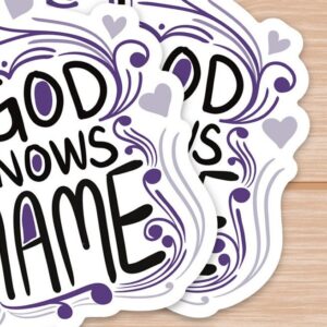 Stack of decorative stickers with My God knows my name text and purple heart designs on wood.